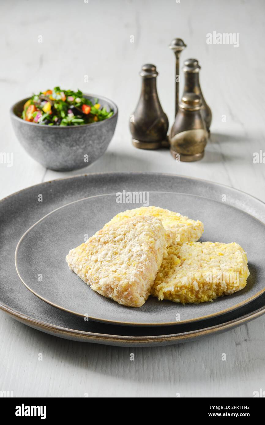 Semifinished squid cutlet in breading Stock Photo