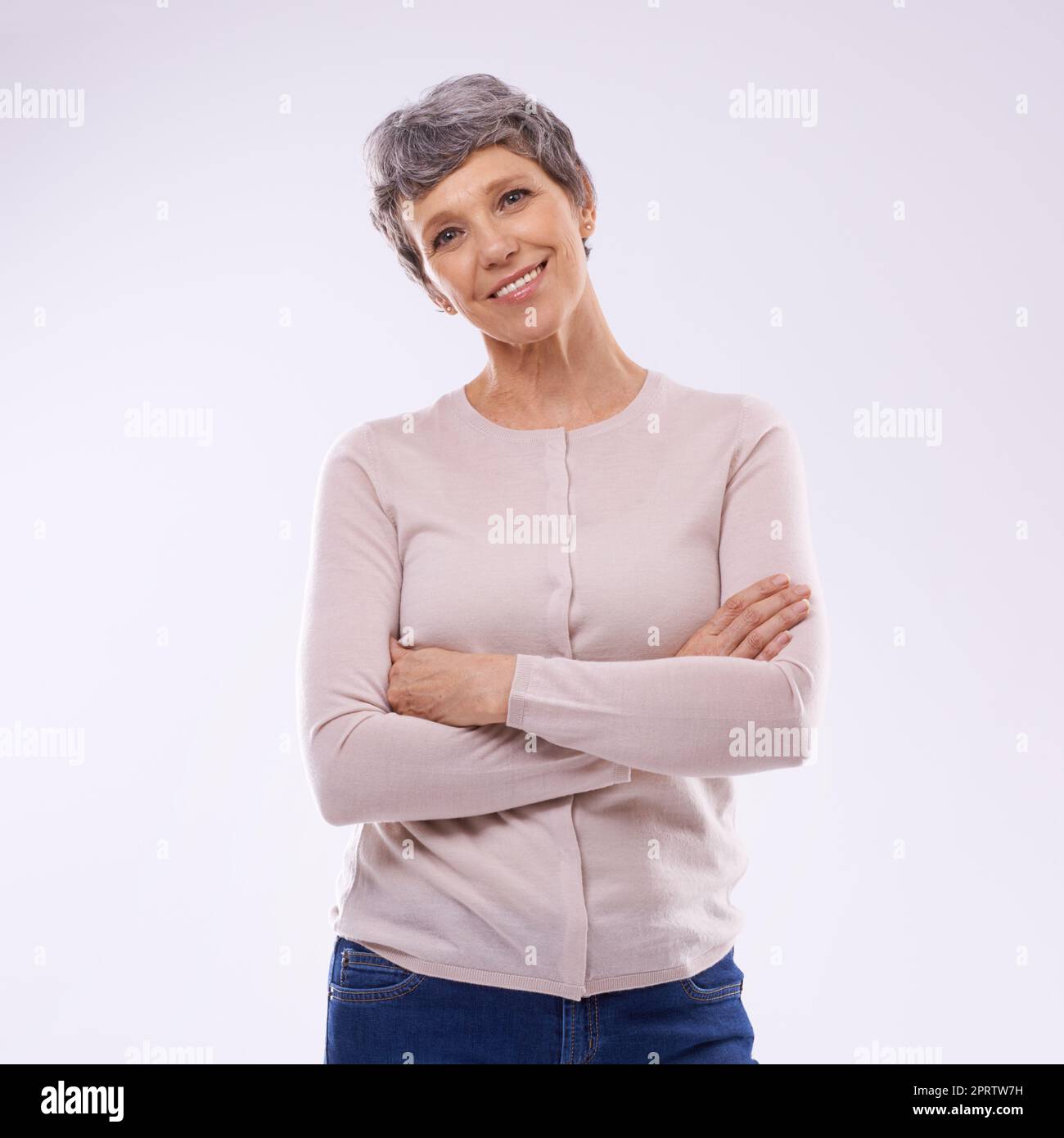 Self-assured maturity. Studio portrait of a happy mature woman against a white background. Stock Photo