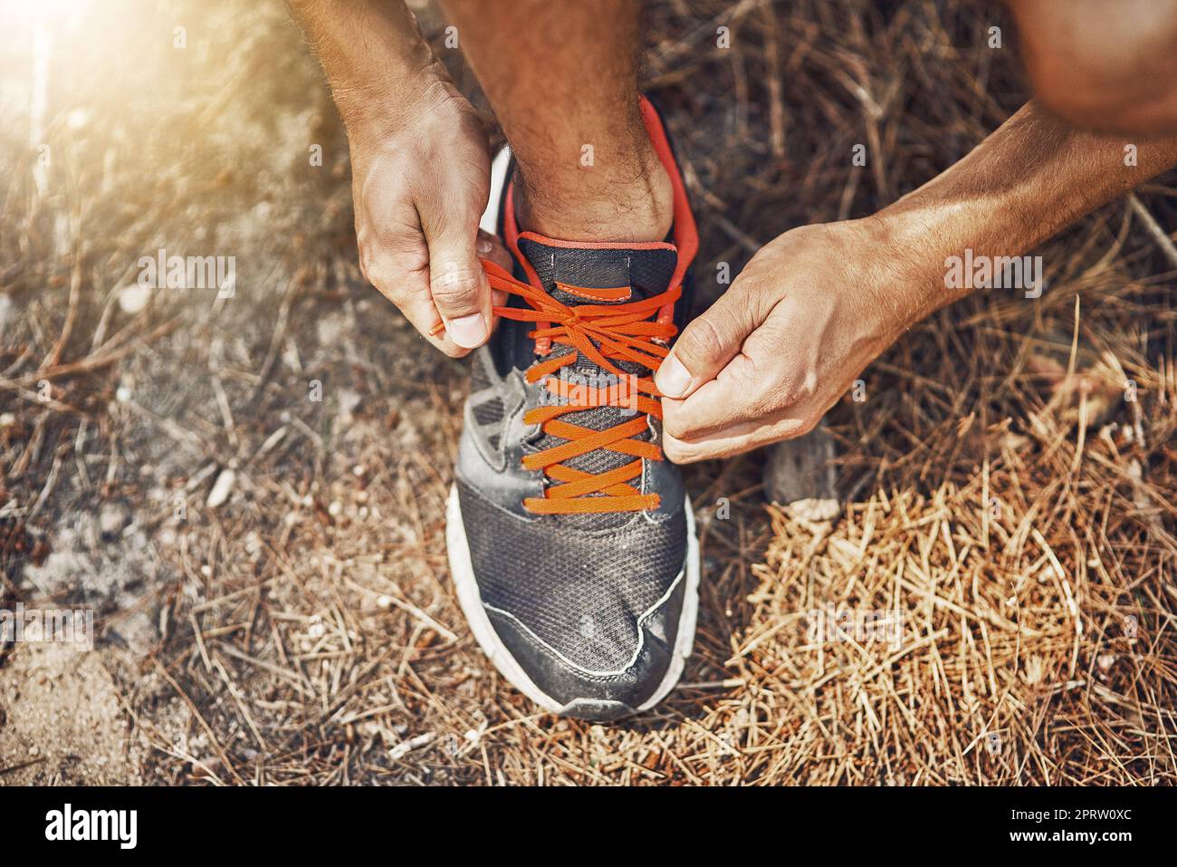 Tie your laces securely to avoid tripping. a young person tying their