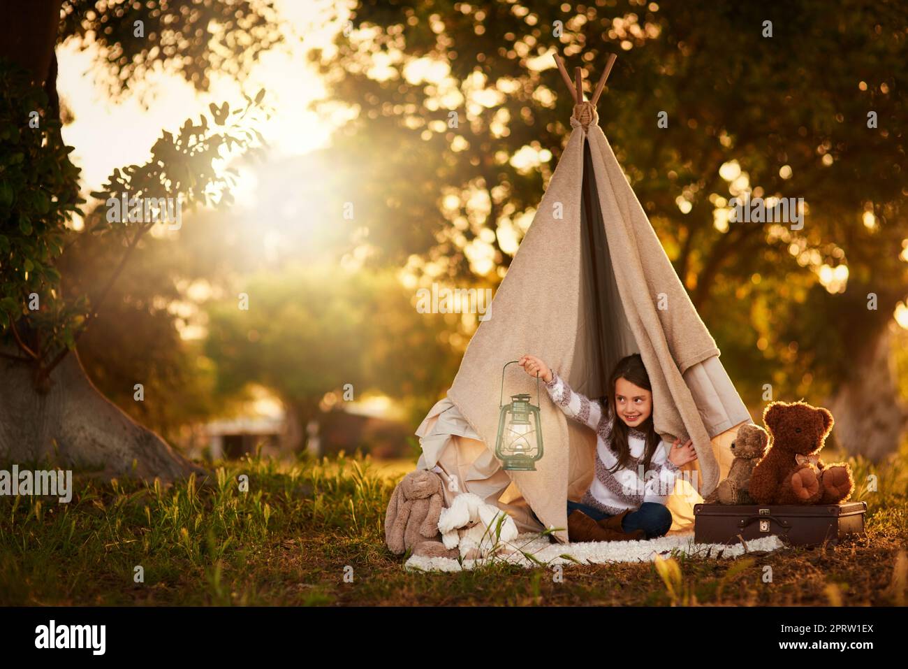 Who will see my little light. a cute little girl playing in her teepee