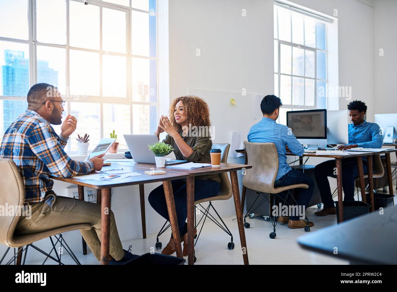 In the business of producing results. two young coworkers having a discussion opposite each