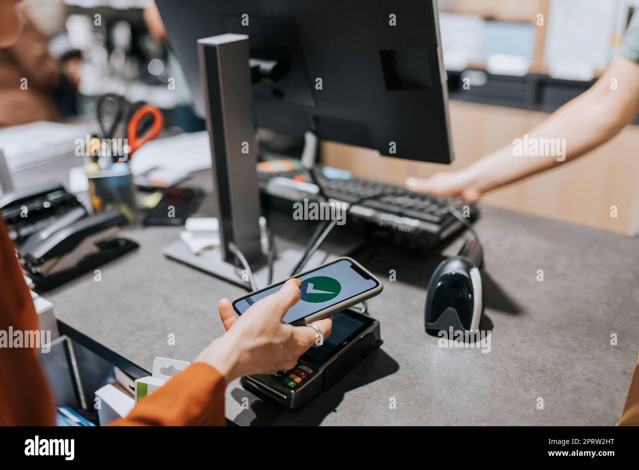 Cropped image of customer scanning credit card reader while paying