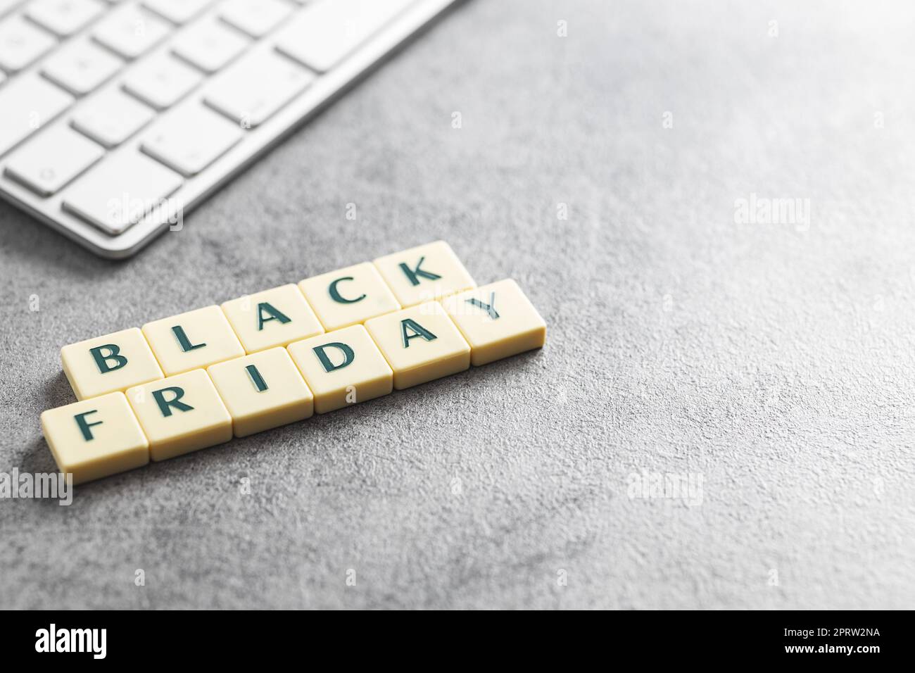 Black friday text and computer keyboard on the gray background. Stock Photo