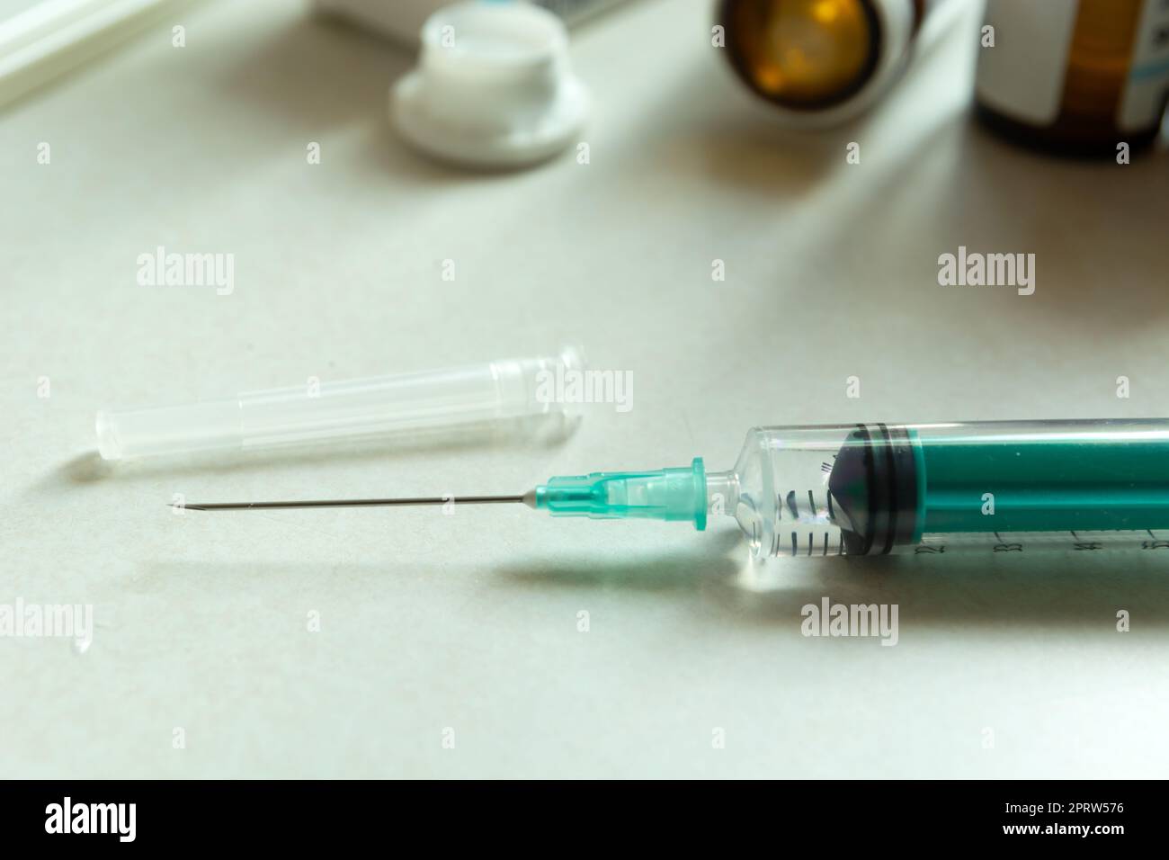 Closeup of a syringe with a needle on the countertop Stock Photo