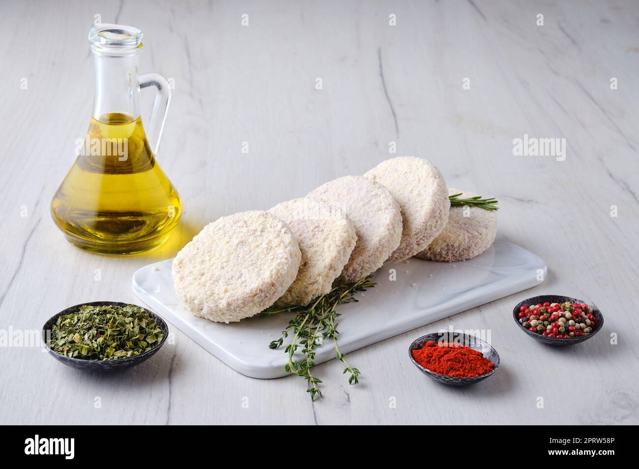 Semifinished beef patties in breading Stock Photo