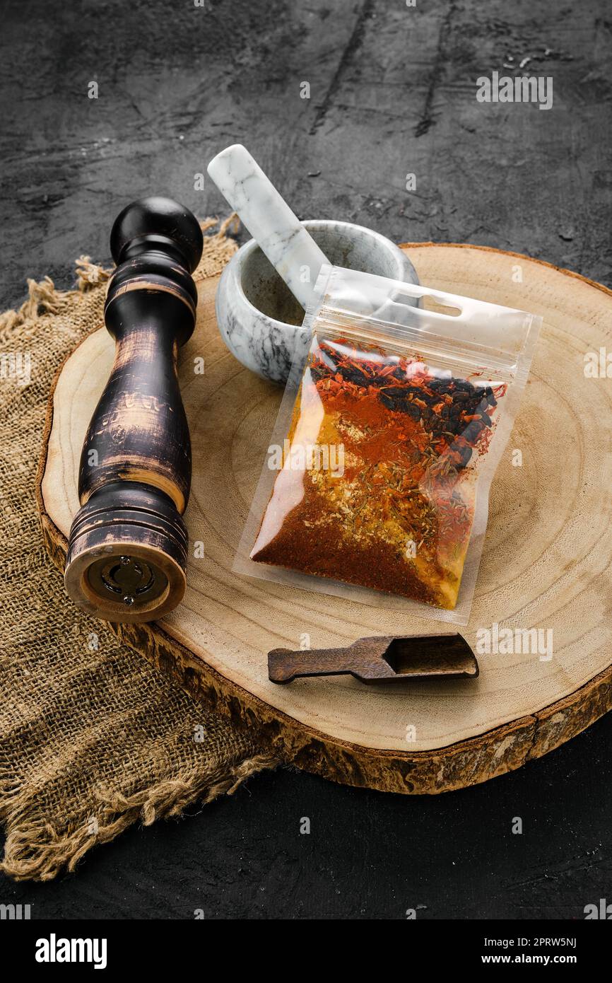 Spices Section Wooden cross section with a set of spices for pilaf in plastic package ...