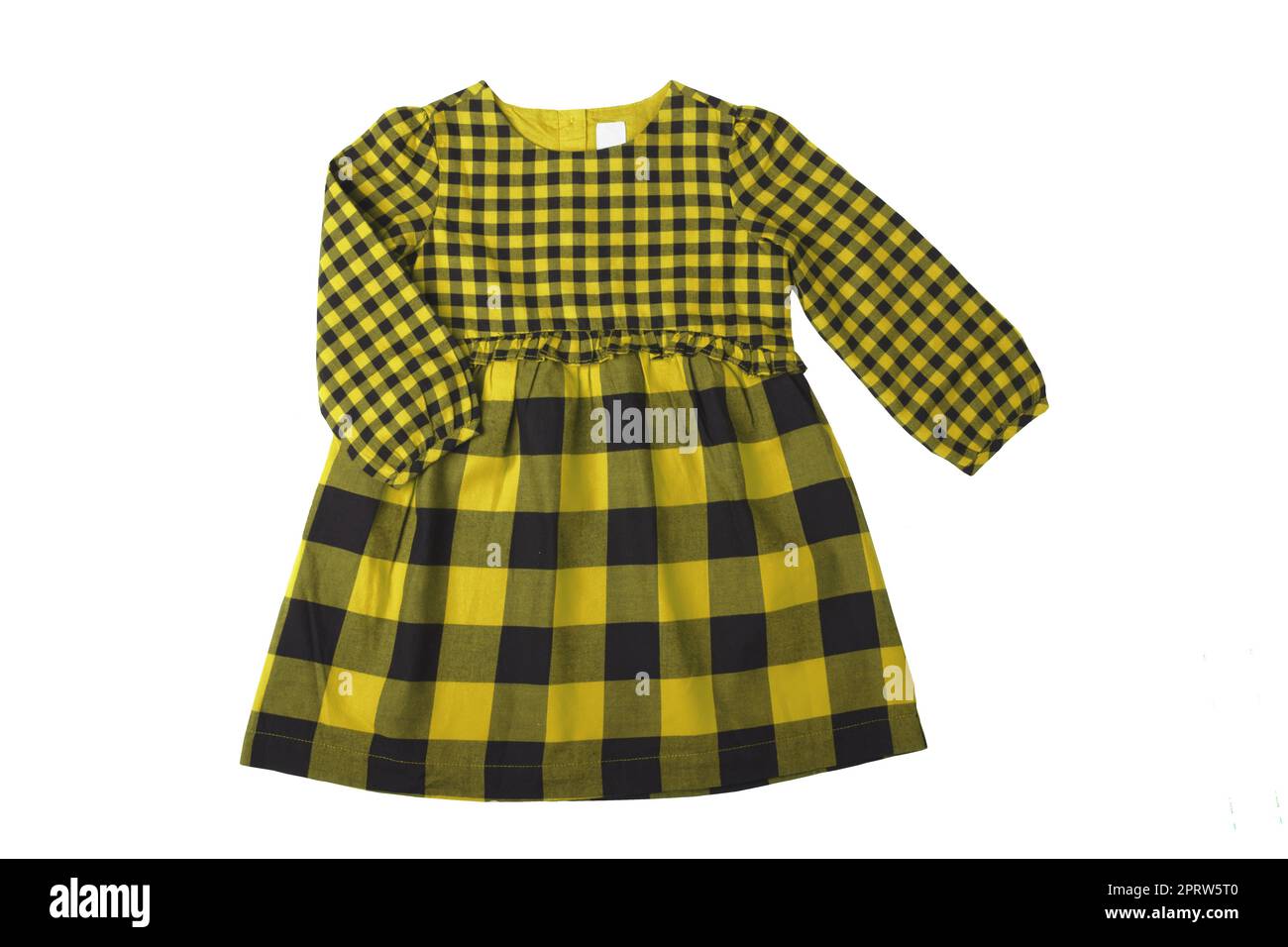 Summer dress isolated. Close-up of a beautiful yellow black checkered little girl dress with long sleeves isolated on a white background. Children autumn fashion. Stock Photo
