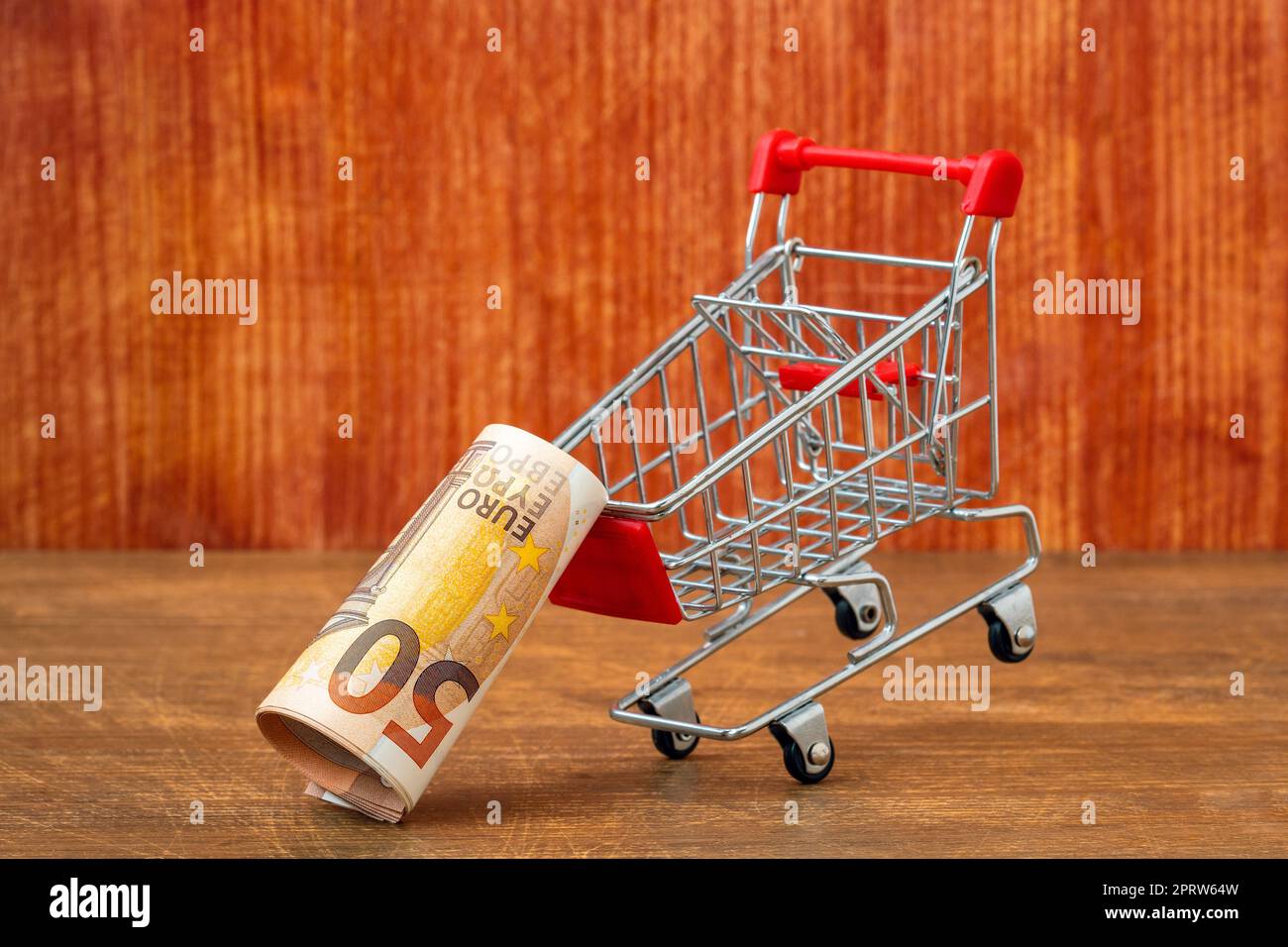 Money roll falling out of a shopping cart Stock Photo Alamy