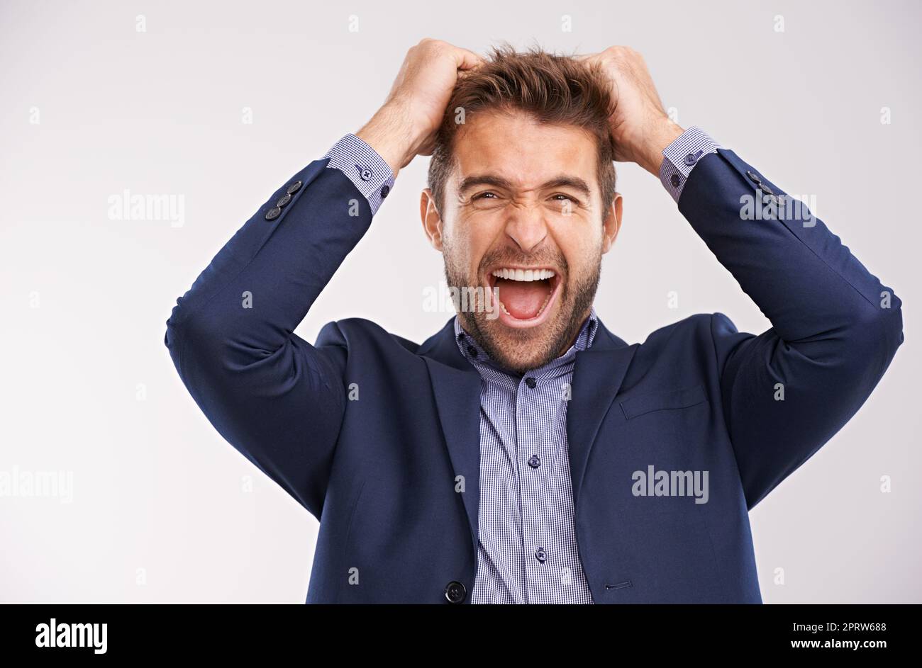 Youve got to be kidding me. Portrait of a excited young businessman celebrating success isolated against white background. Stock Photo