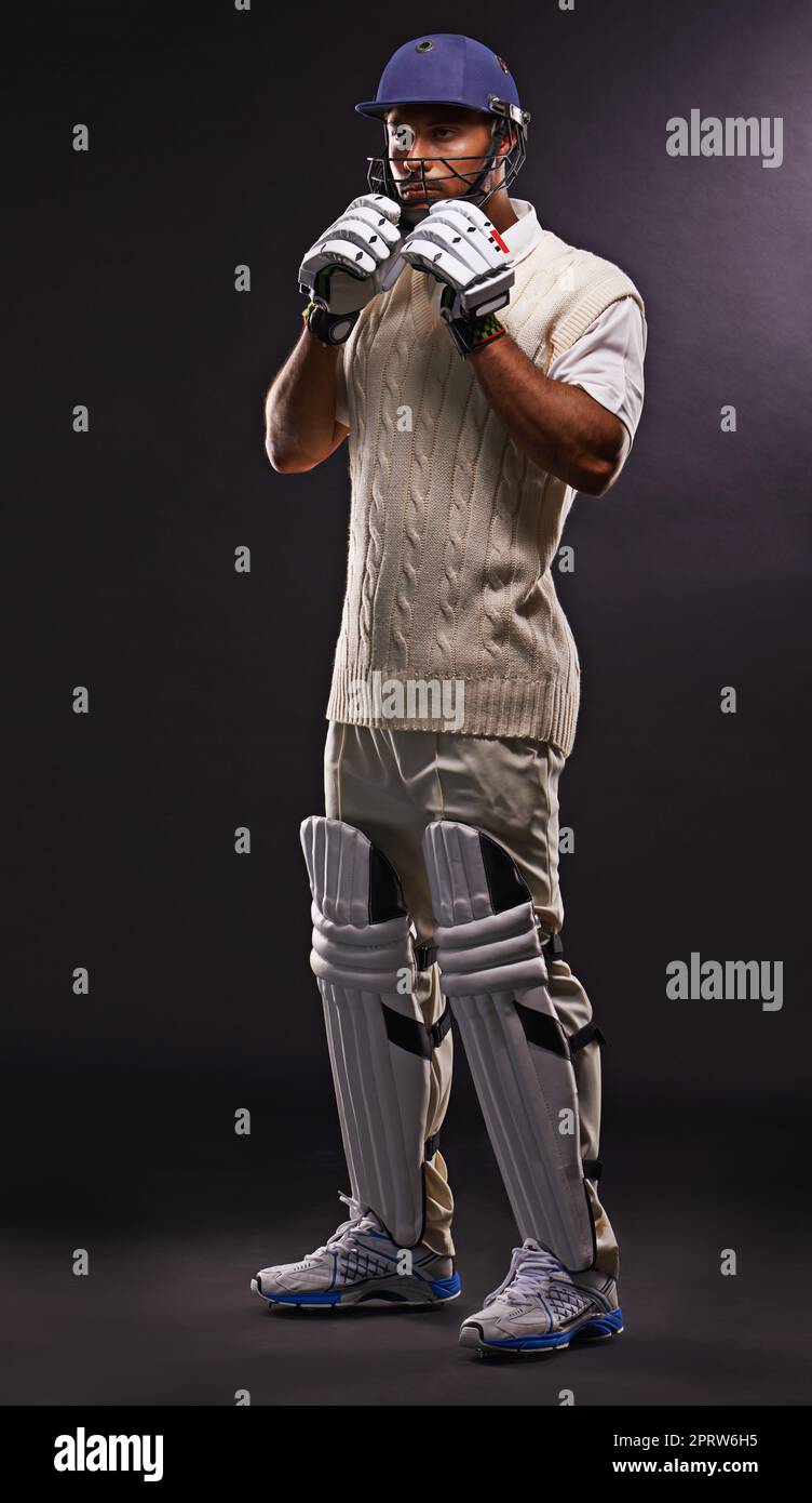 Padded up. A cropped shot of an ethnic young man in cricket attire