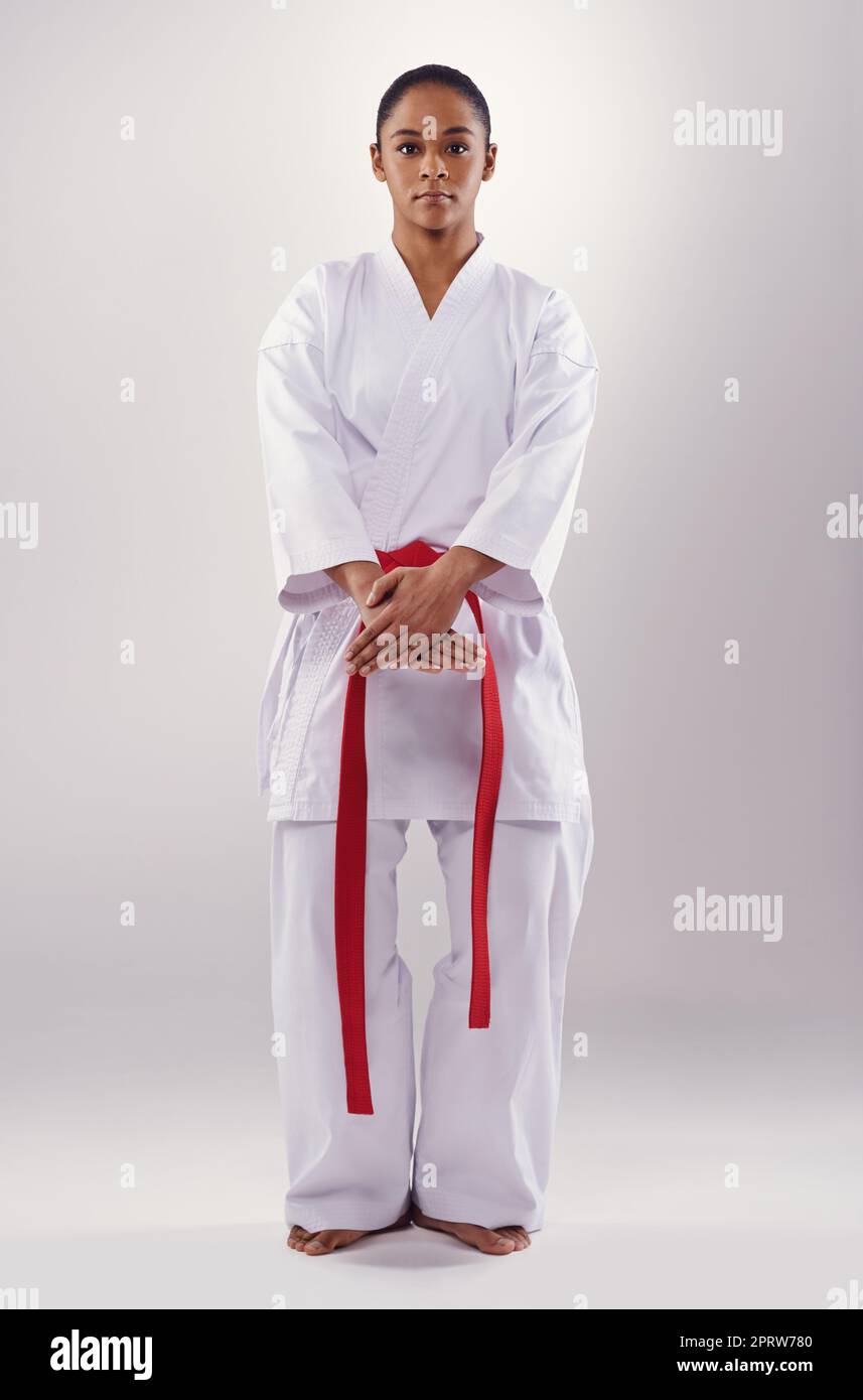 Shes well drilled in her fighting style. a young woman doing karate. Stock Photo