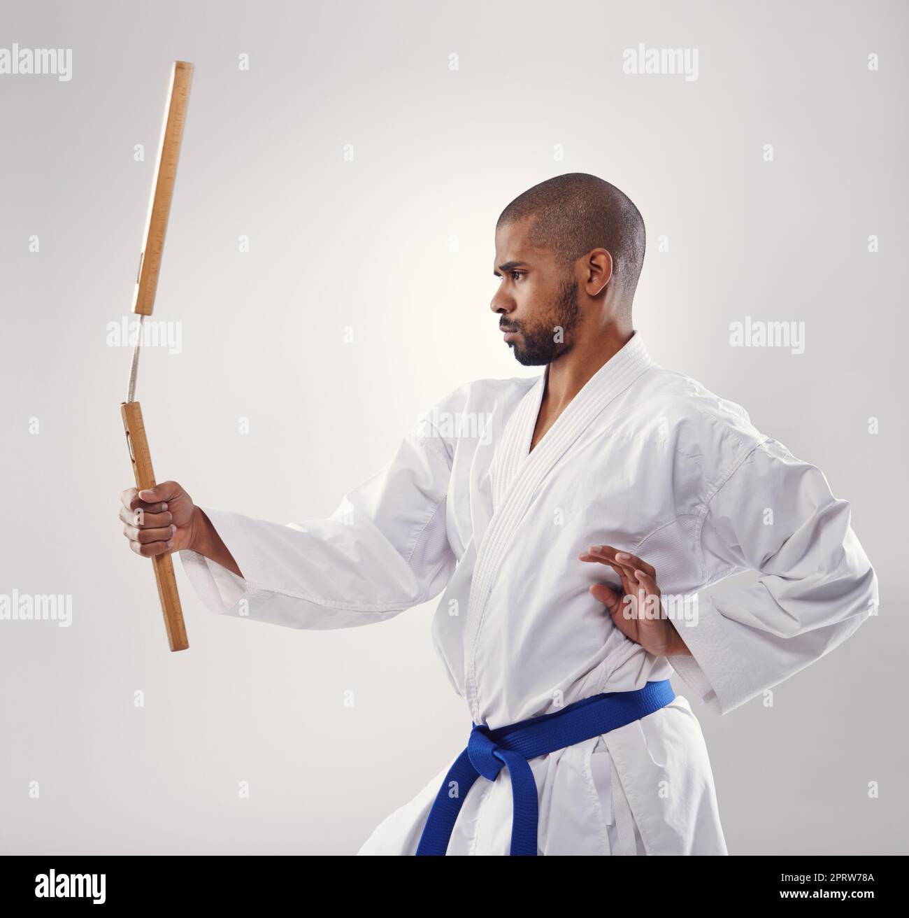 Wielding his nunchucks like a pro. An african man doing karate Stock
