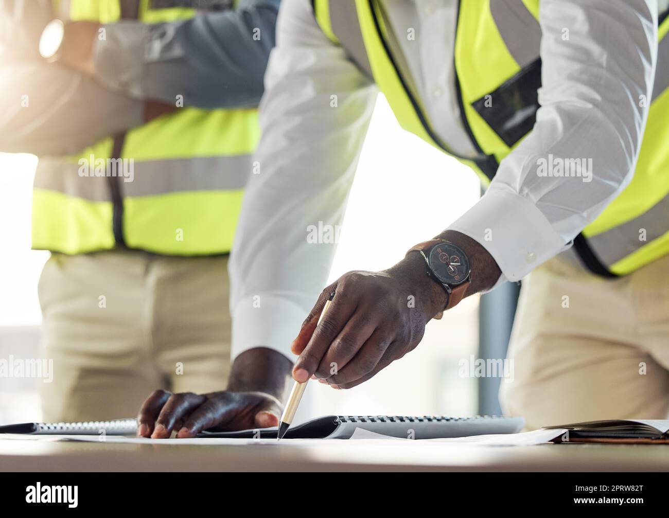 Construction team, architect show plan or blueprint to worker, for work on building or development. Black contractor or engineer, with safety clothing planning new design or architecture sketch Stock Photo