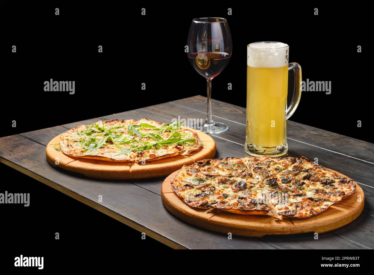 https://c8.alamy.com/comp/2PRW83T/two-pizzas-and-a-glass-of-beer-and-red-wine-on-a-table-2PRW83T.jpg