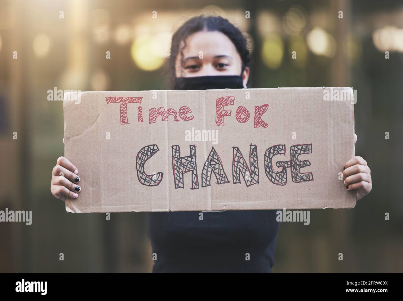 Woman, protest and sign for change in human rights, gender based violence or equality against a bokeh background. Female activist protesting holding billboard message to voice community improvement Stock Photo