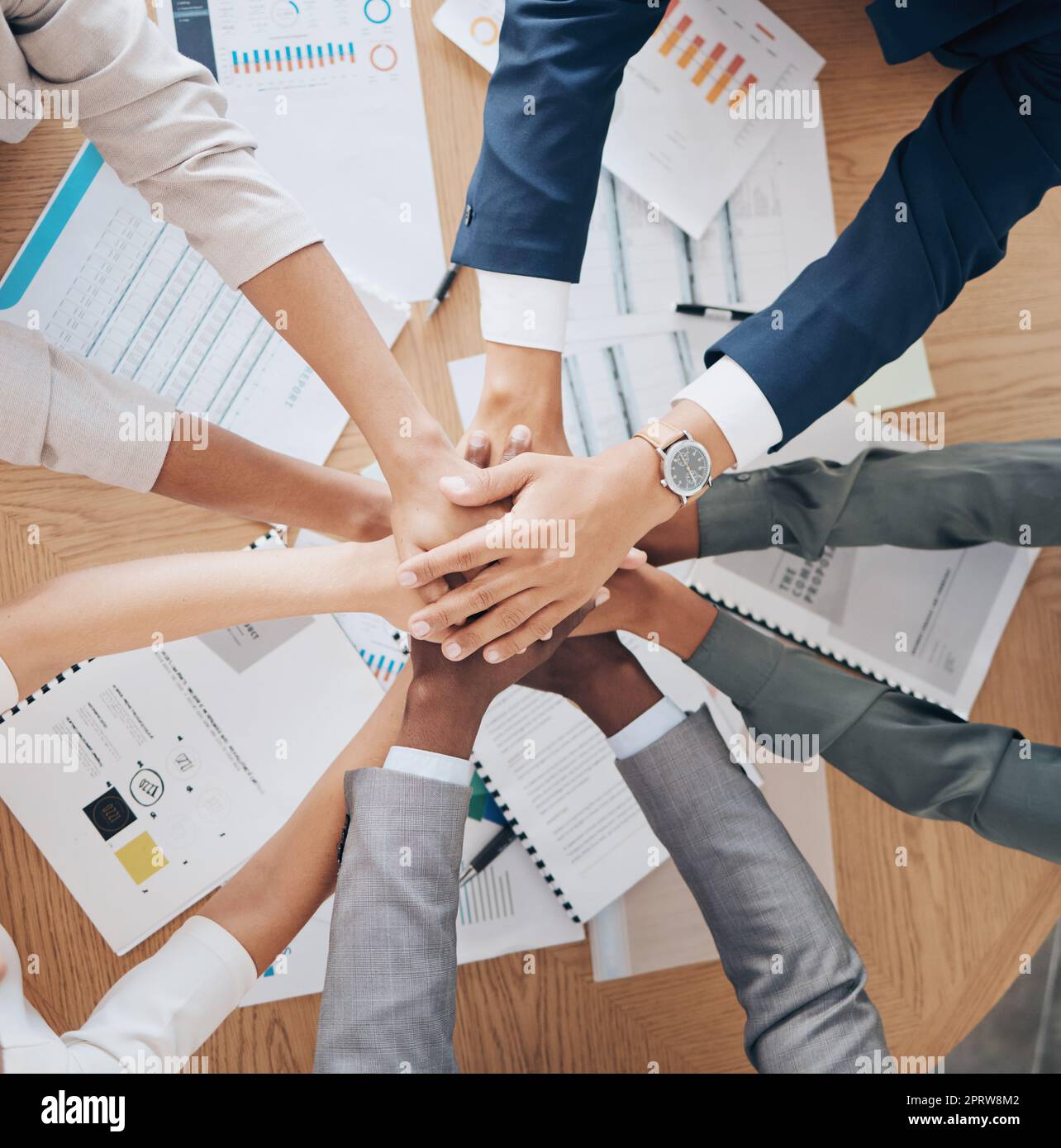 Team hands, collaboration and meeting of business people in agreement together above papers at work in the office. Group of employee hand in teamwork, agree and pile for company goal strategy or plan Stock Photo