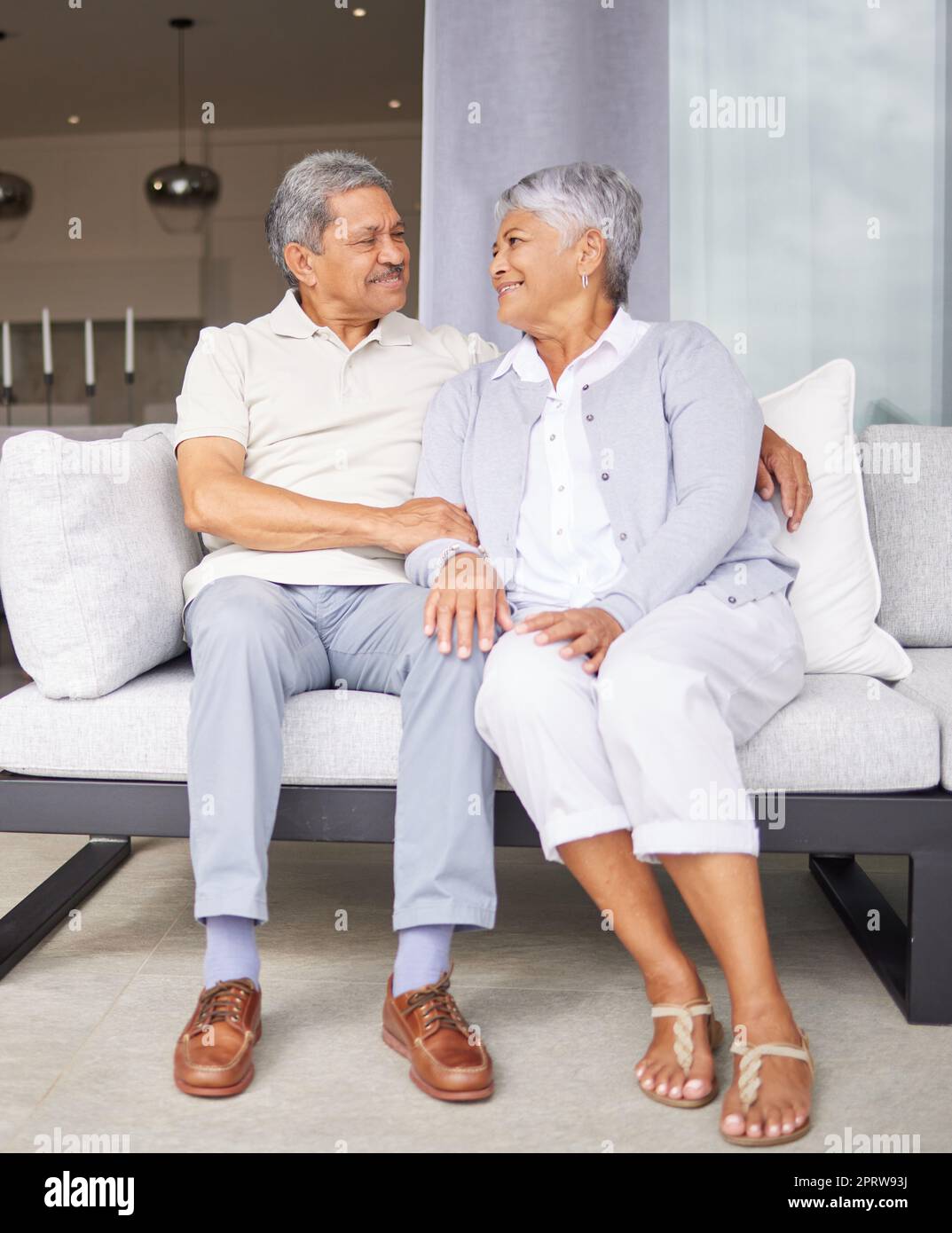 Retirement, love and marriage with senior couple sitting on sofa together for care, support and wellness. Elderly, trust and embrace with old age married man and woman in family home Stock Photo
