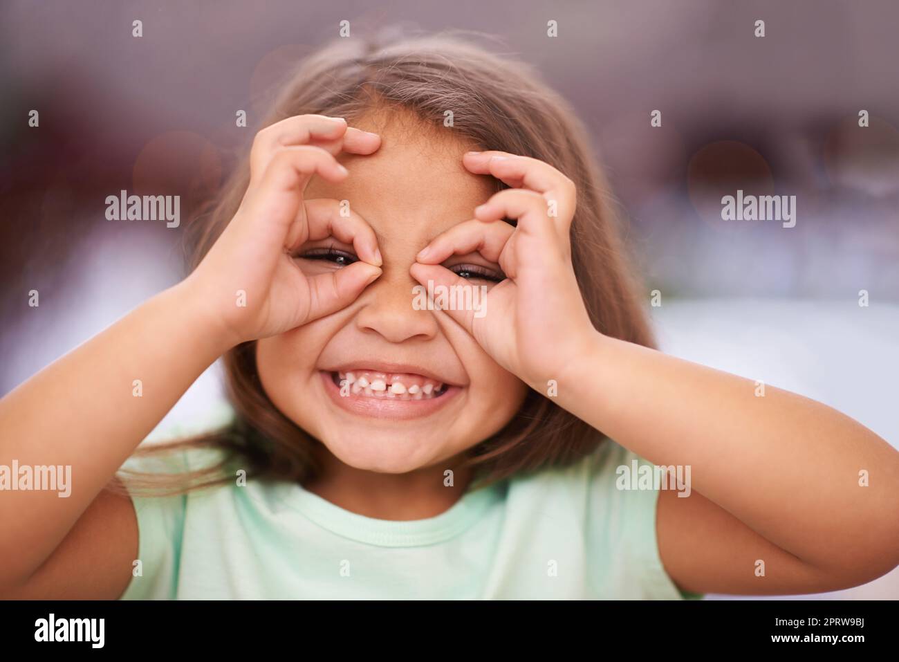 Little girls with dreams become women with vision. a playful little girl with pulling a funny face. Stock Photo