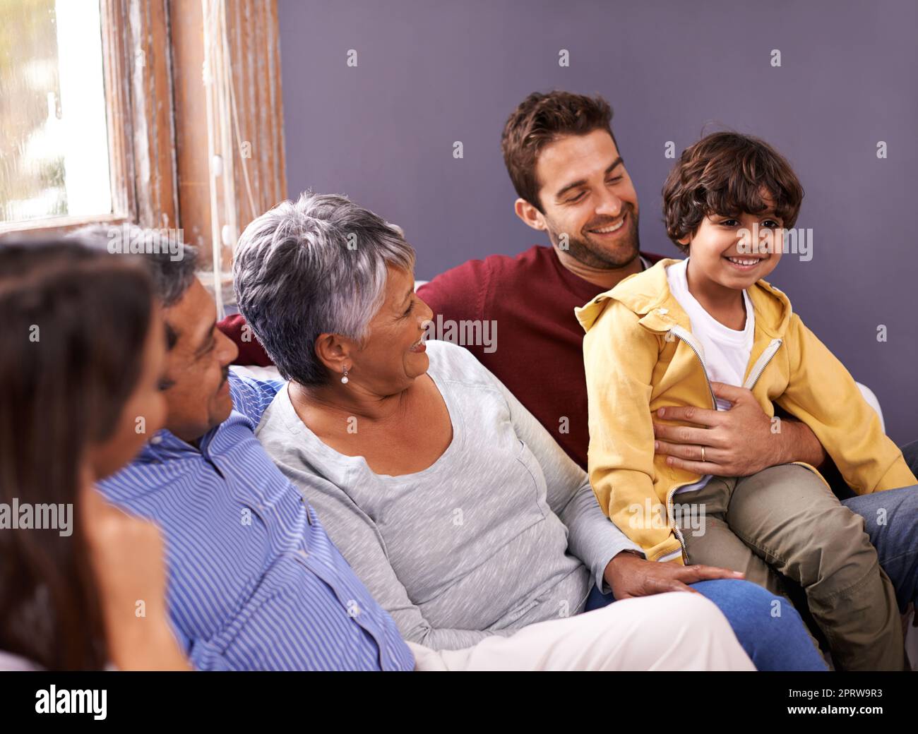 He brings joy to the family. A shot of a family bonding together in the living room. Stock Photo