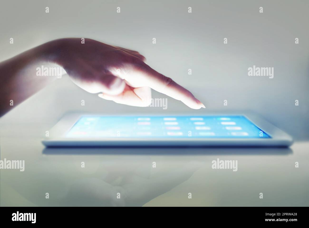 Data at her touch. Cropped closeup of a womans hand above a digital tablet. Stock Photo