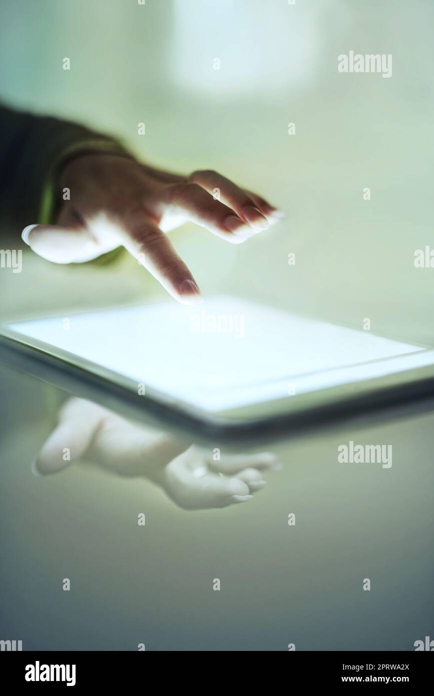 Intuitive technology. Cropped closeup of a womans hand above a digital tablet. Stock Photo