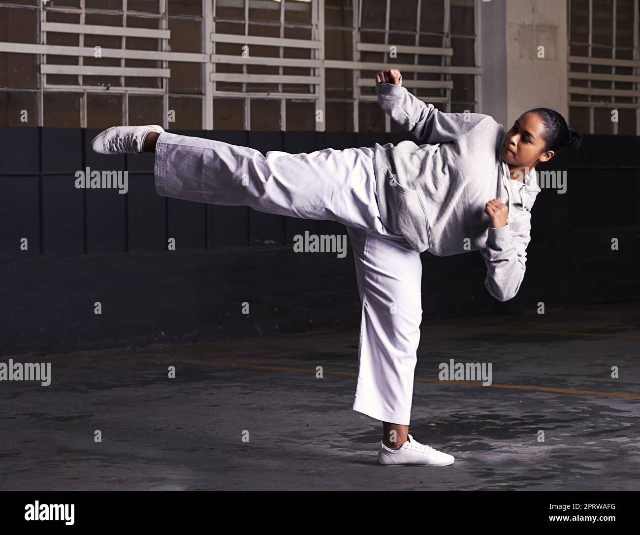 Balance and speed is key in martial arts. a young woman practicing