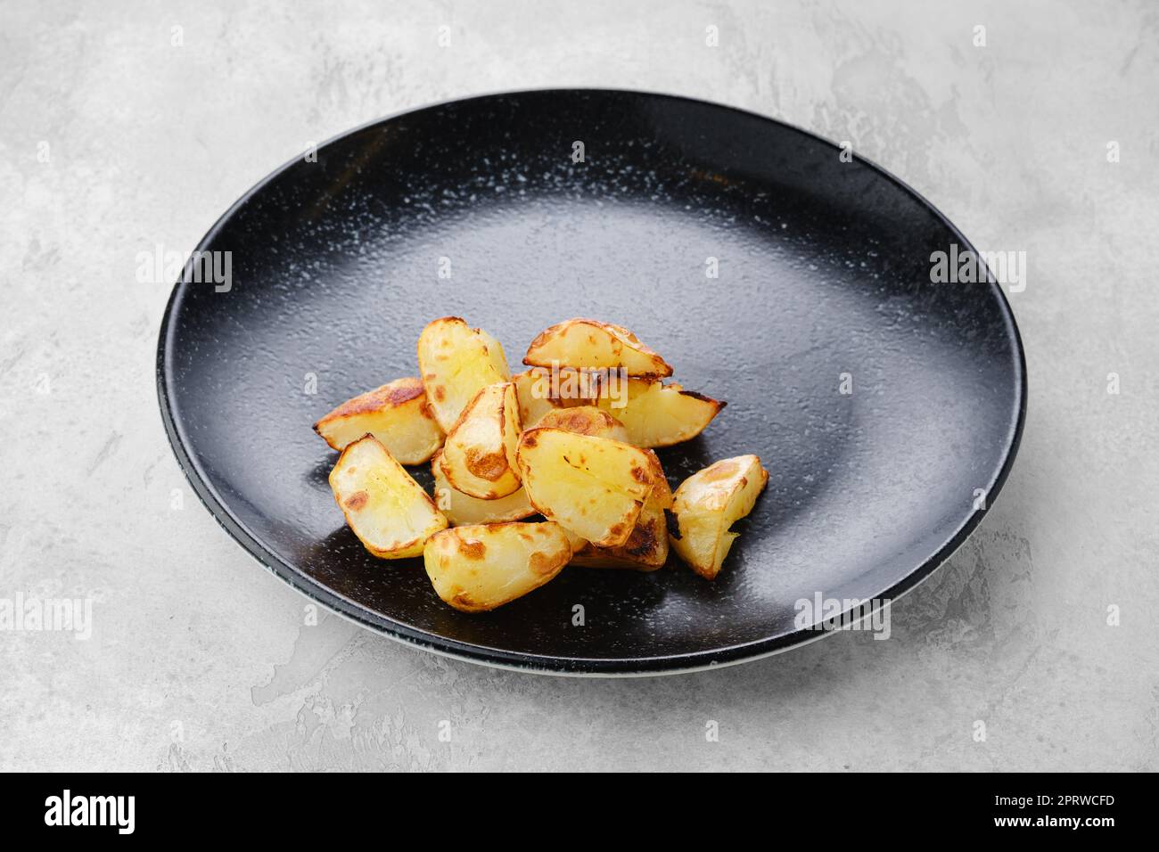 Slices of boiled potatoes fried in oil Stock Photo