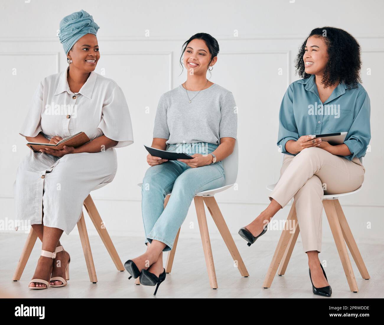 Global women, diversity and company business meeting with digital tablet, notebook and paper documents. Smile, happy and inclusive teamwork collaboration in office innovation and brand strategy idea Stock Photo