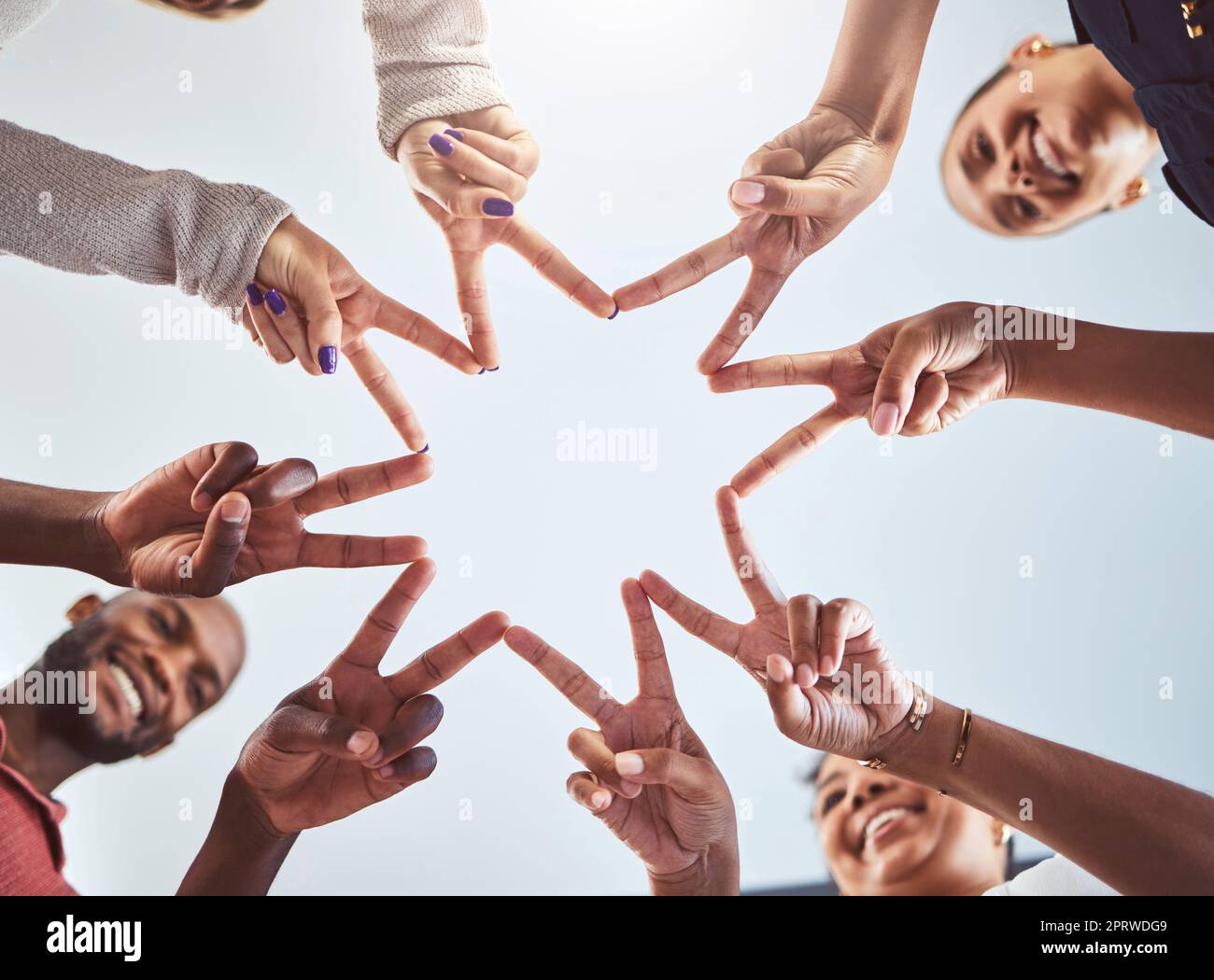 Friends doing a star with hands, with synergy as a team at a team building event and being outdoors in the sun. Business success means productive staff, showing unity and using collaboration Stock Photo