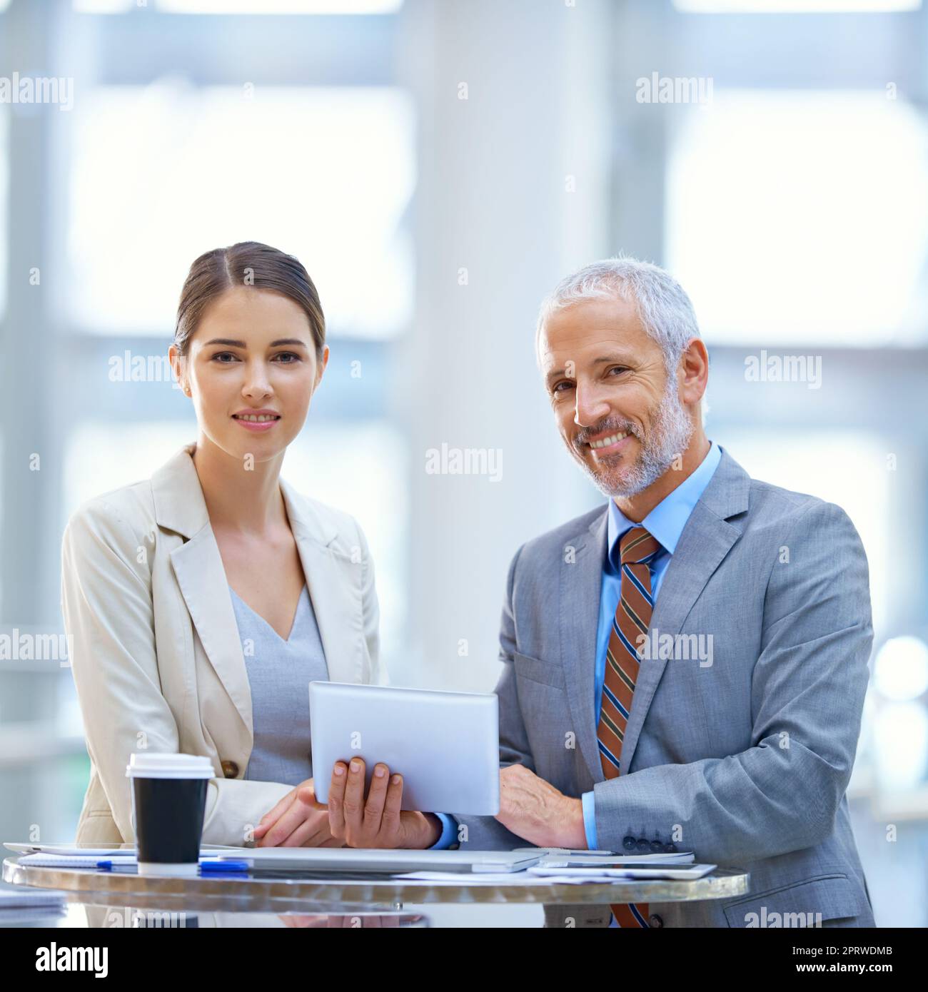 Combining talent and experience. Portrait of two business colleagues standing with a digital tablet. Stock Photo