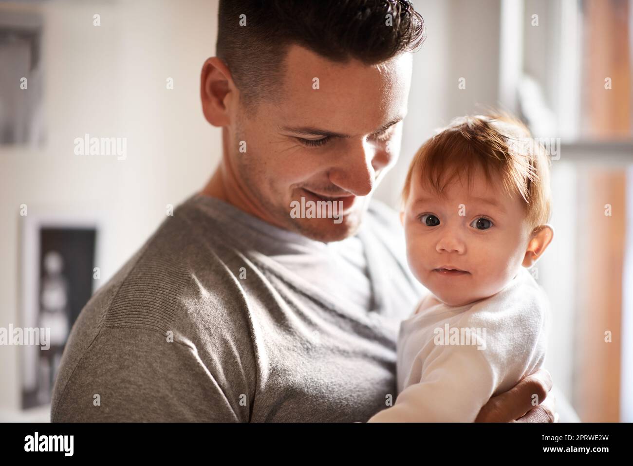 Shes my angel. Portrait of a cute baby girl being held by her father. Stock Photo