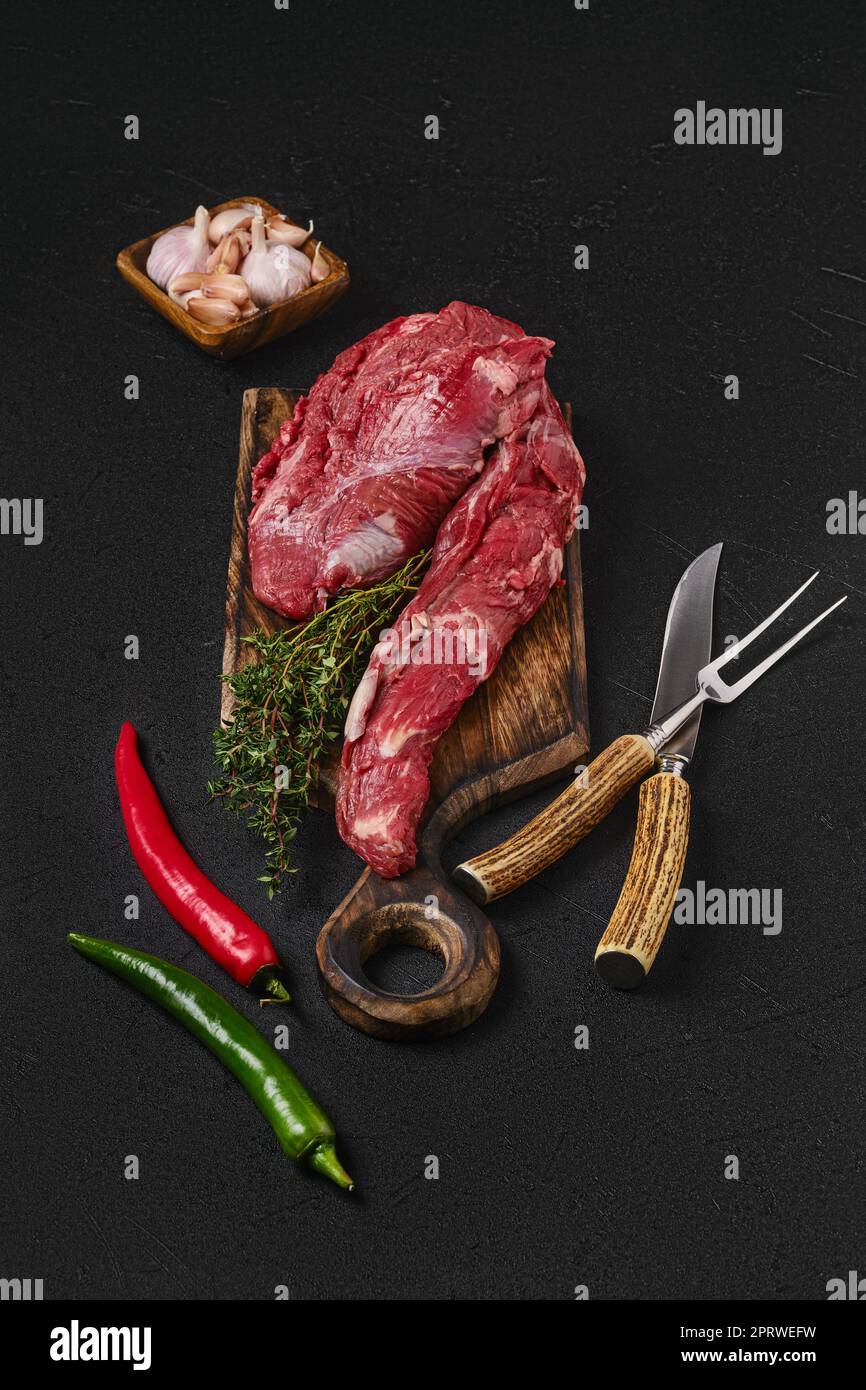 Raw beef whole tenderloin for steak fillet mignon on black background Stock Photo
