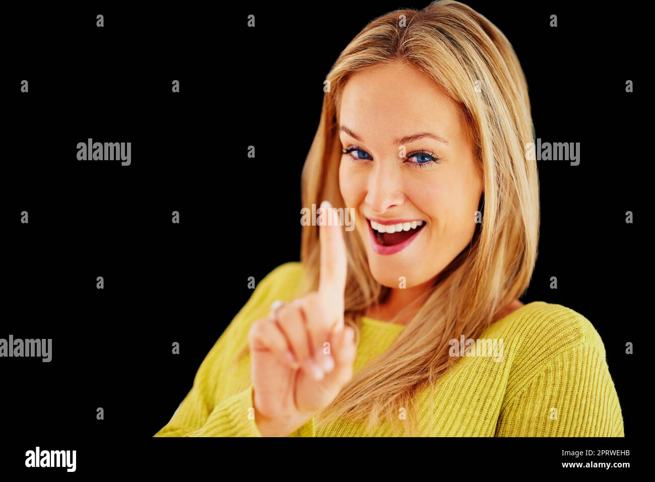 Numero Uno. Studio shot of a beautiful young blonde woman with one finger raised. Stock Photo
