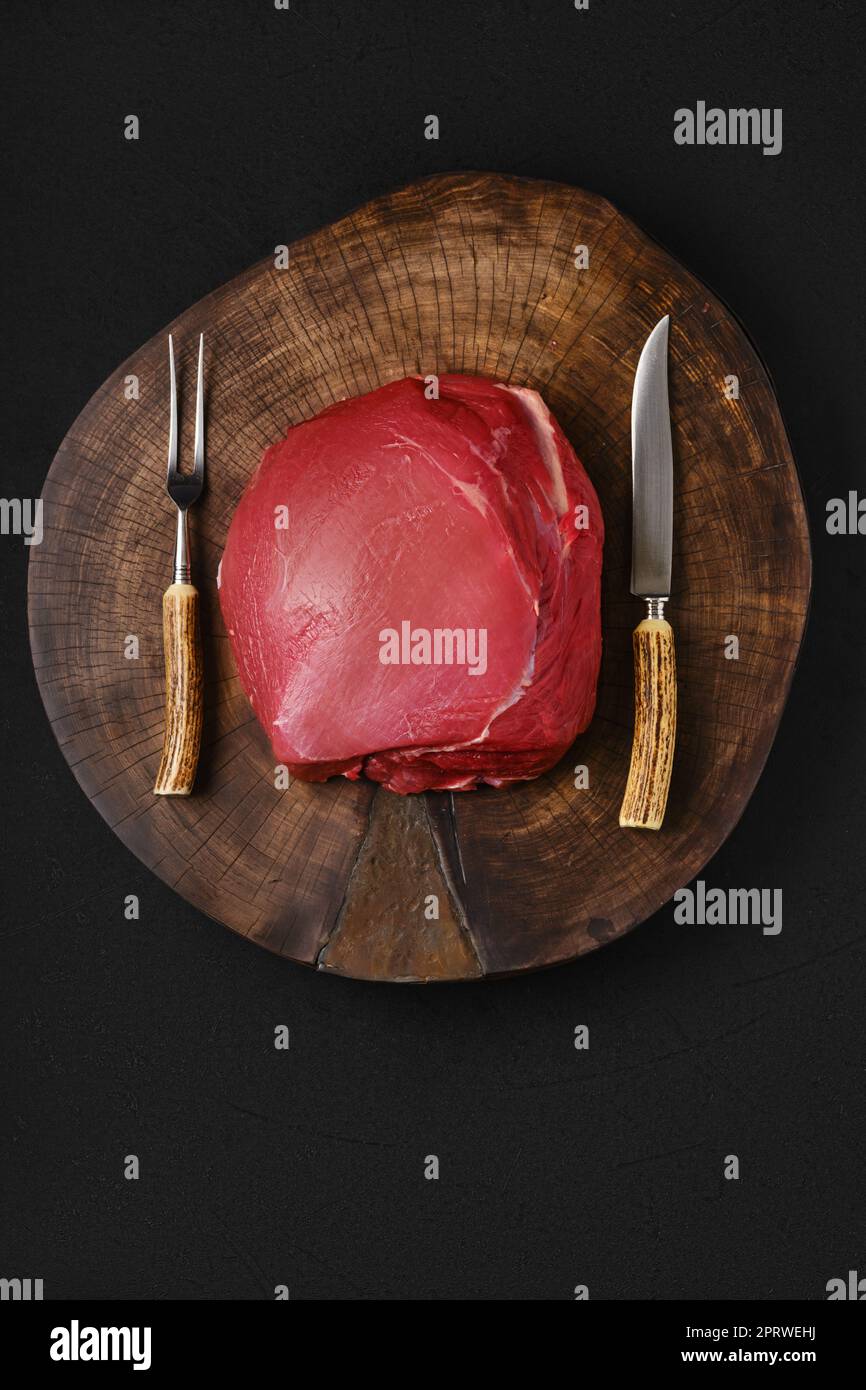 Raw beef top round meat on wooden slab Stock Photo Alamy