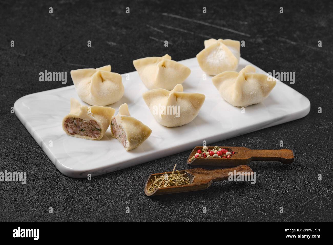 Spicy beef dumplings on marble serving plate Stock Photo
