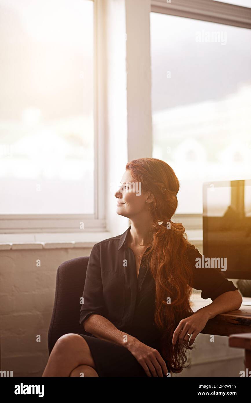 Dont dream your life, live your dream. a young businesswoman sitting at her desk. Stock Photo
