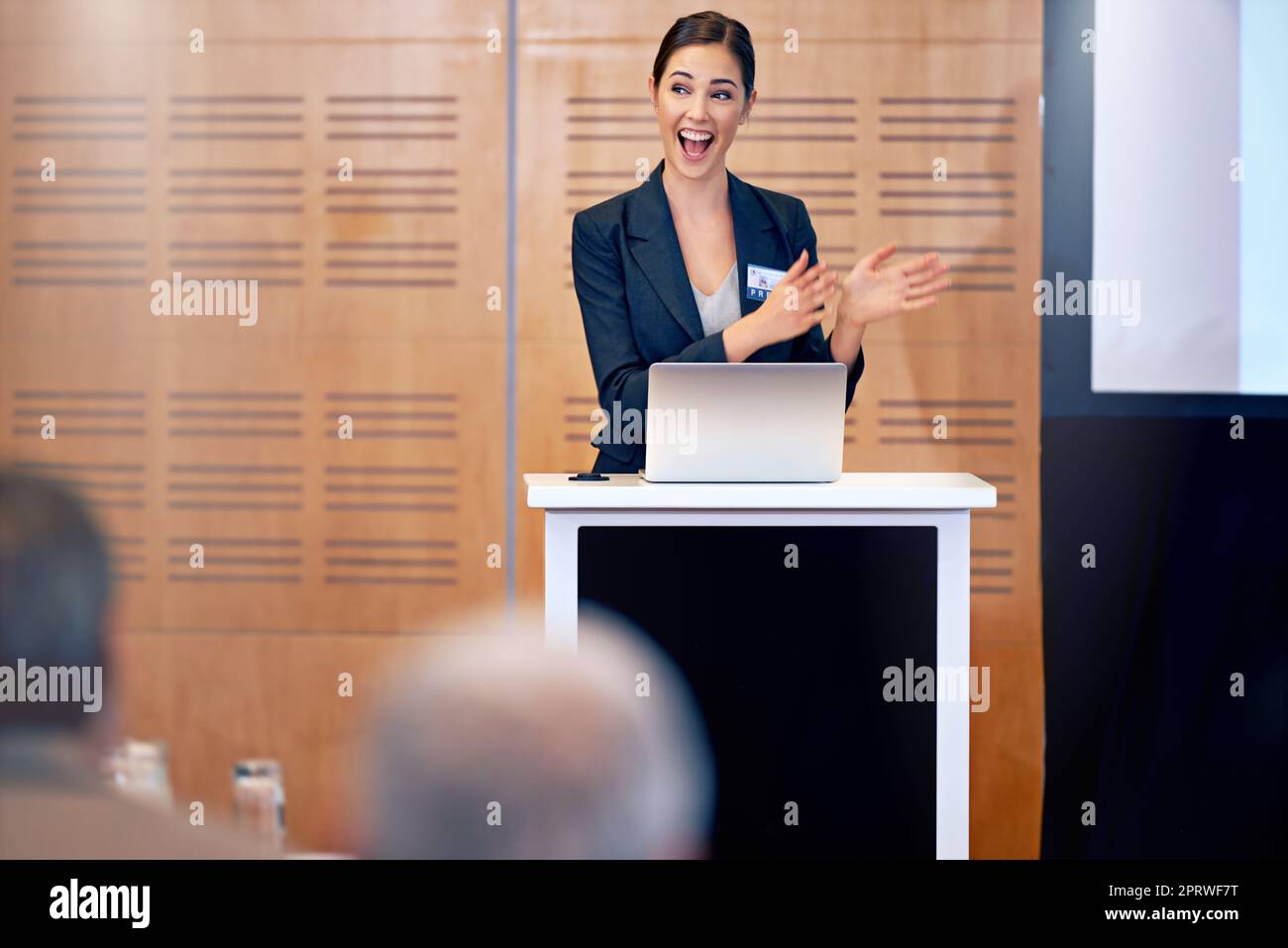 Joy is the engine of growth. A beautiful young businesswoman giving a presentation at a press conference. Stock Photo
