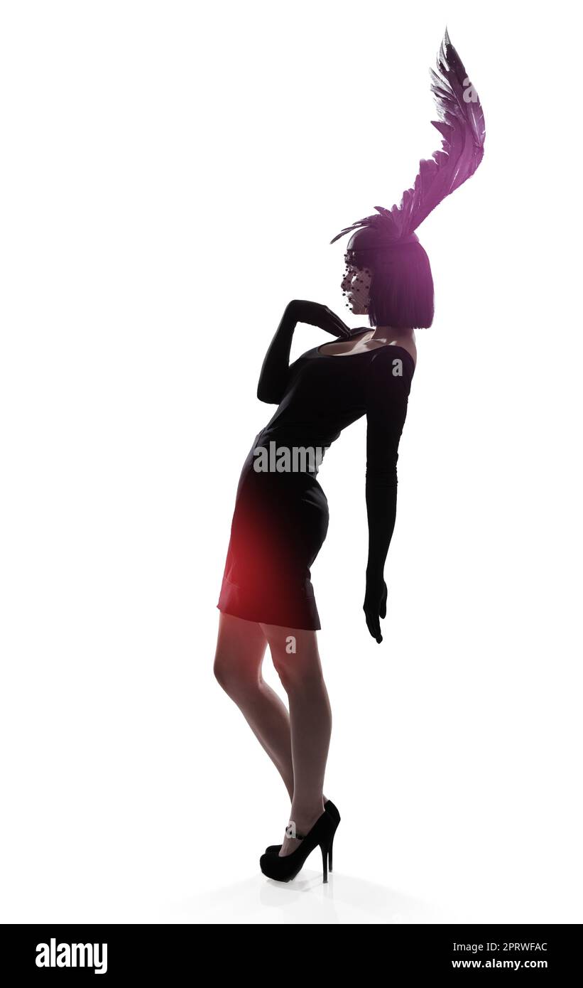 Feeling light as a feather. a young woman in a wing-shaped headpiece standing in a studio. Stock Photo