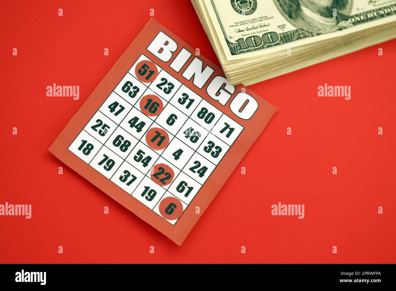 Red bingo board or playing card for winning chips and stack of dollar