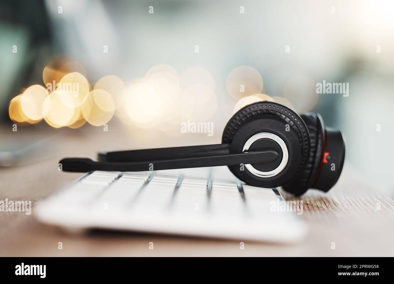 Call center headphones, computer keyboard and telemarketing background in office for contact us, video call and virtual online consulting. Zoom of customer support help desk, technology and connectio Stock Photo