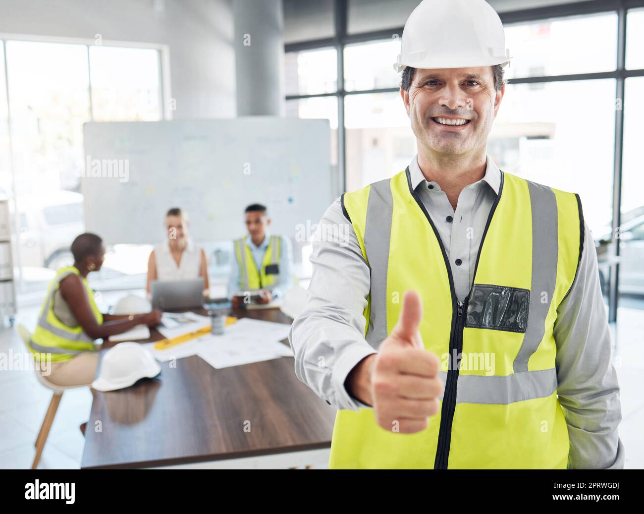 Thumbs up, leader and architect team working on architecture design for a home, house or skyscraper building. Senior man, manager or supervisor with thumbsup for motivation, teamwork or collaboration Stock Photo