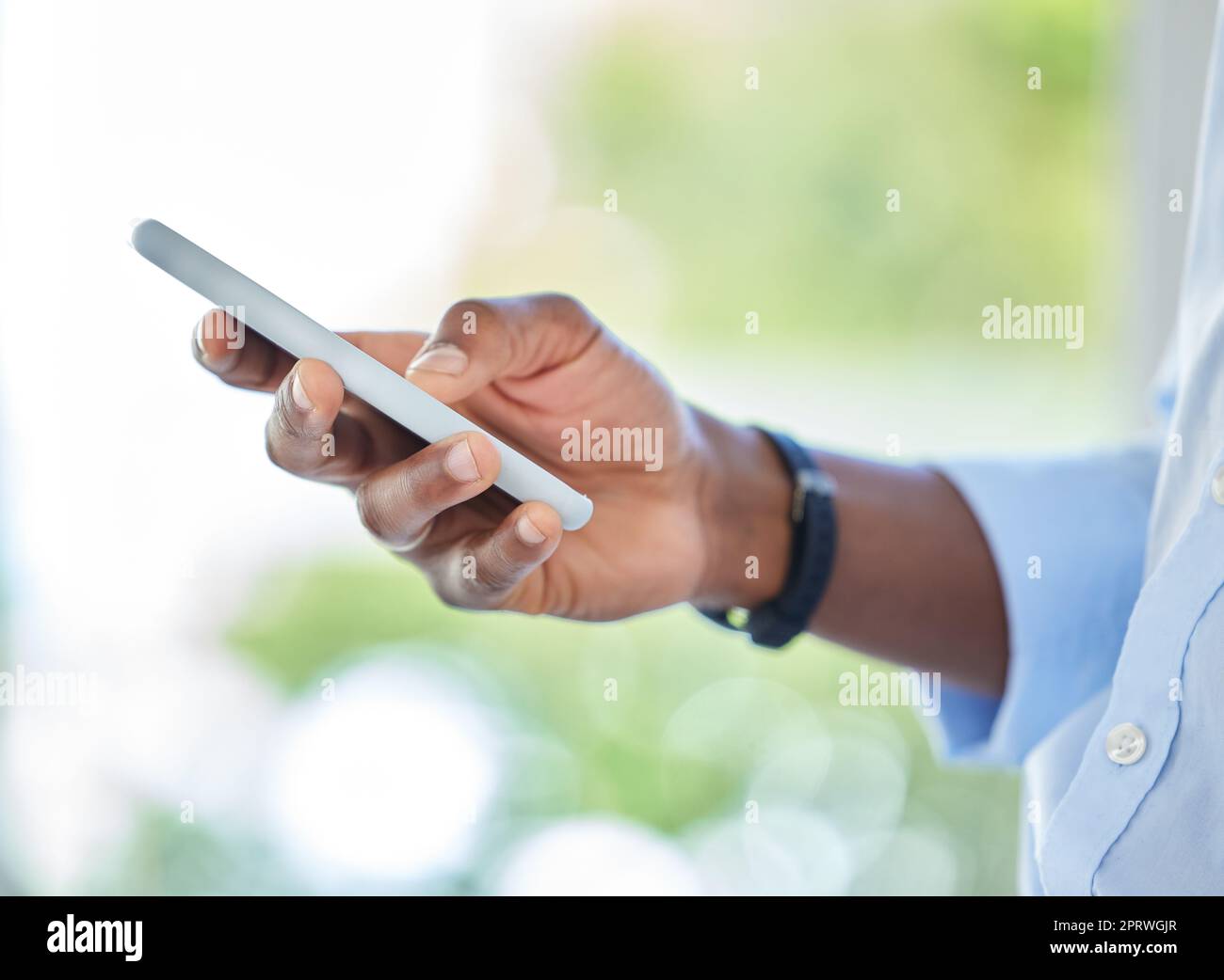 Digital, phone and search with hand of black man on mobile device for social media, text or message. Online, internet and web with closeup businessman scrolling technology, communication and contact Stock Photo