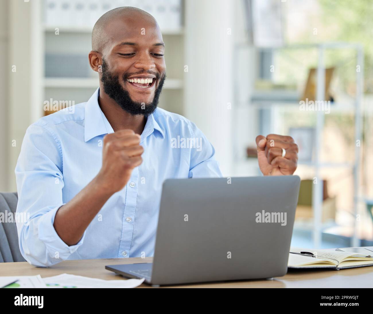 Success, excited and business man with laptop happy about profit and growth of stock market, investment or trading. Celebration by a professional trader over forex, nft and bitcoin cash stock growing Stock Photo