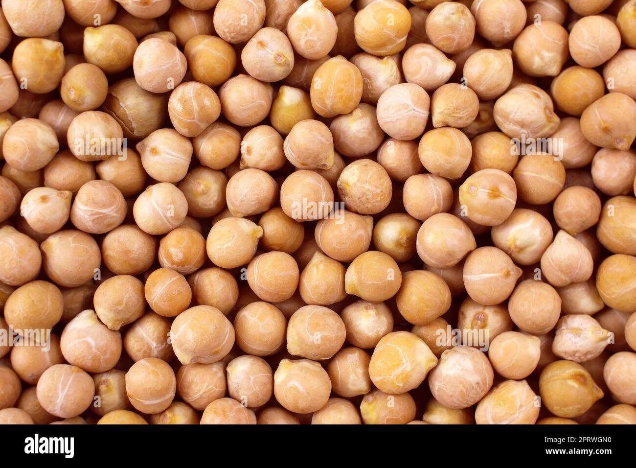 Top view of yellow dried chickpeas or chick peas texture close up. Stock Photo