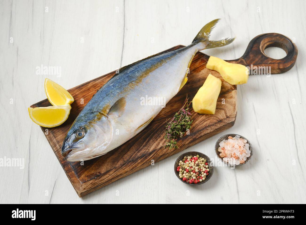 Whole fresh chinook on wooden cutting board Stock Photo