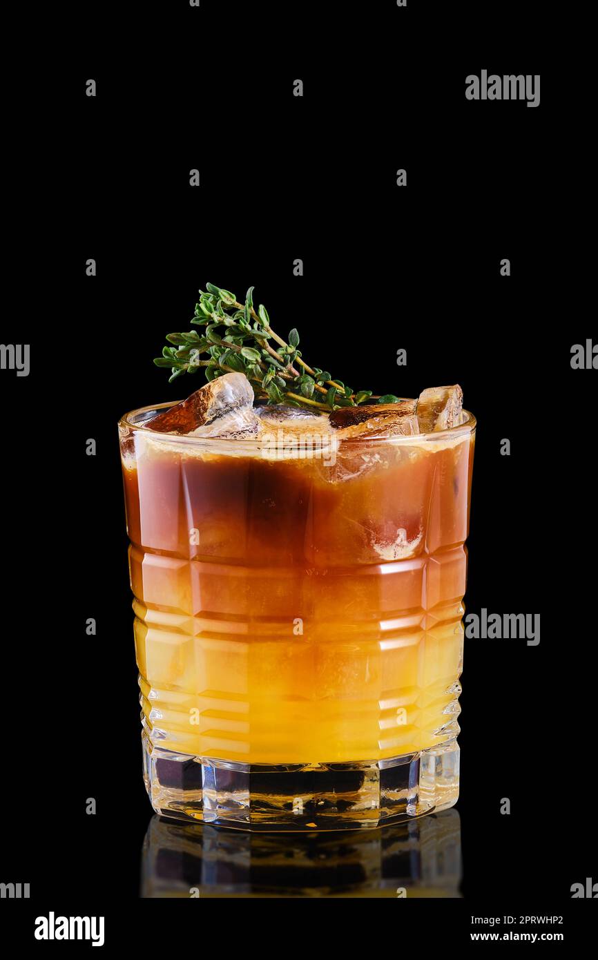Espresso and tonic with orange syrup and thyme Stock Photo