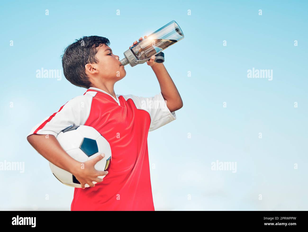 https://c8.alamy.com/comp/2PRWPPW/training-sports-and-football-with-child-drinking-water-for-fitness-health-or-endurance-exercise-wellness-summer-and-workout-with-young-soccer-play-2PRWPPW.jpg