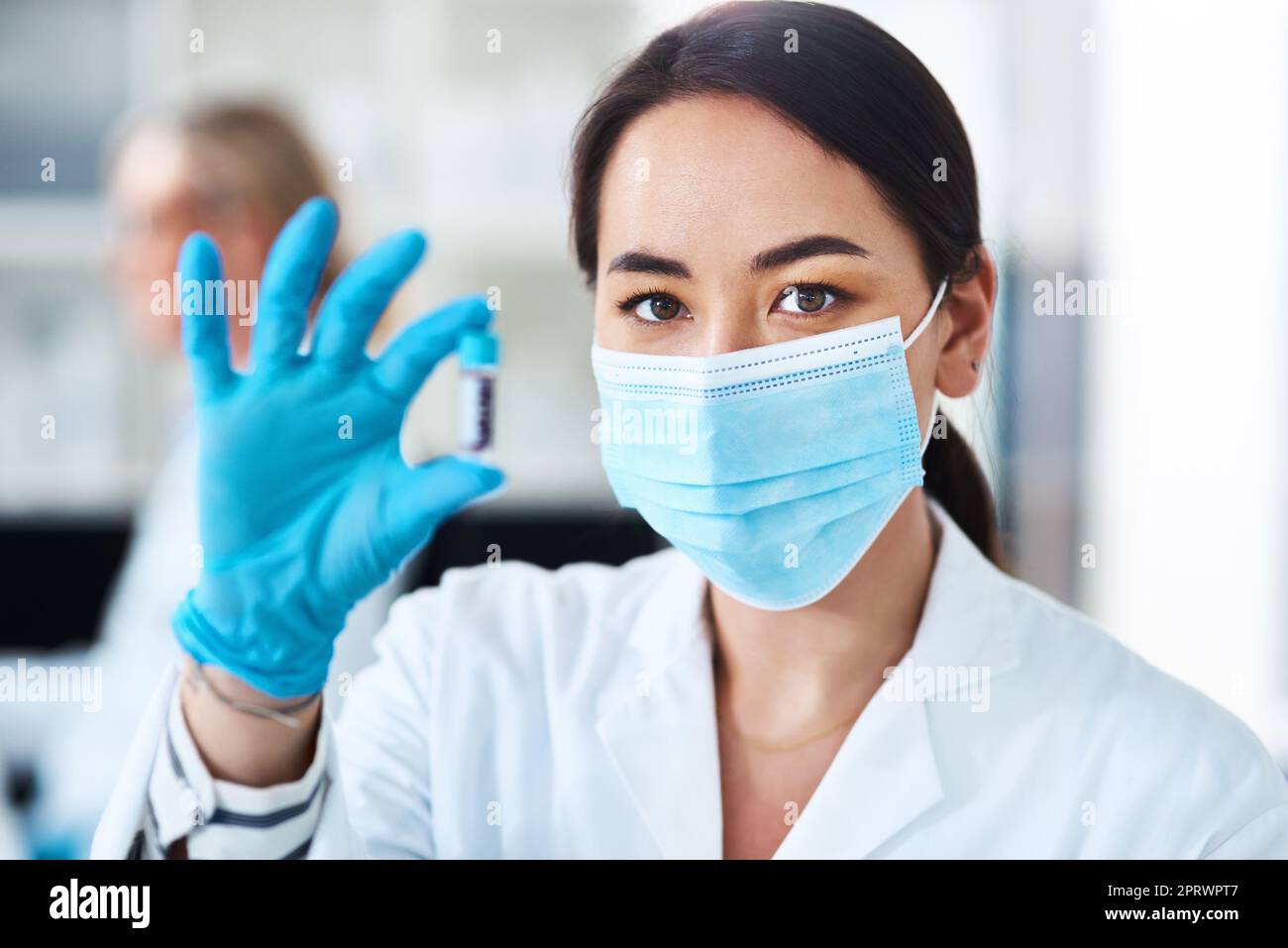This treatment is ready to undergo trialling. Portrait of a young scientist analysing samples in a lab. Stock Photo
