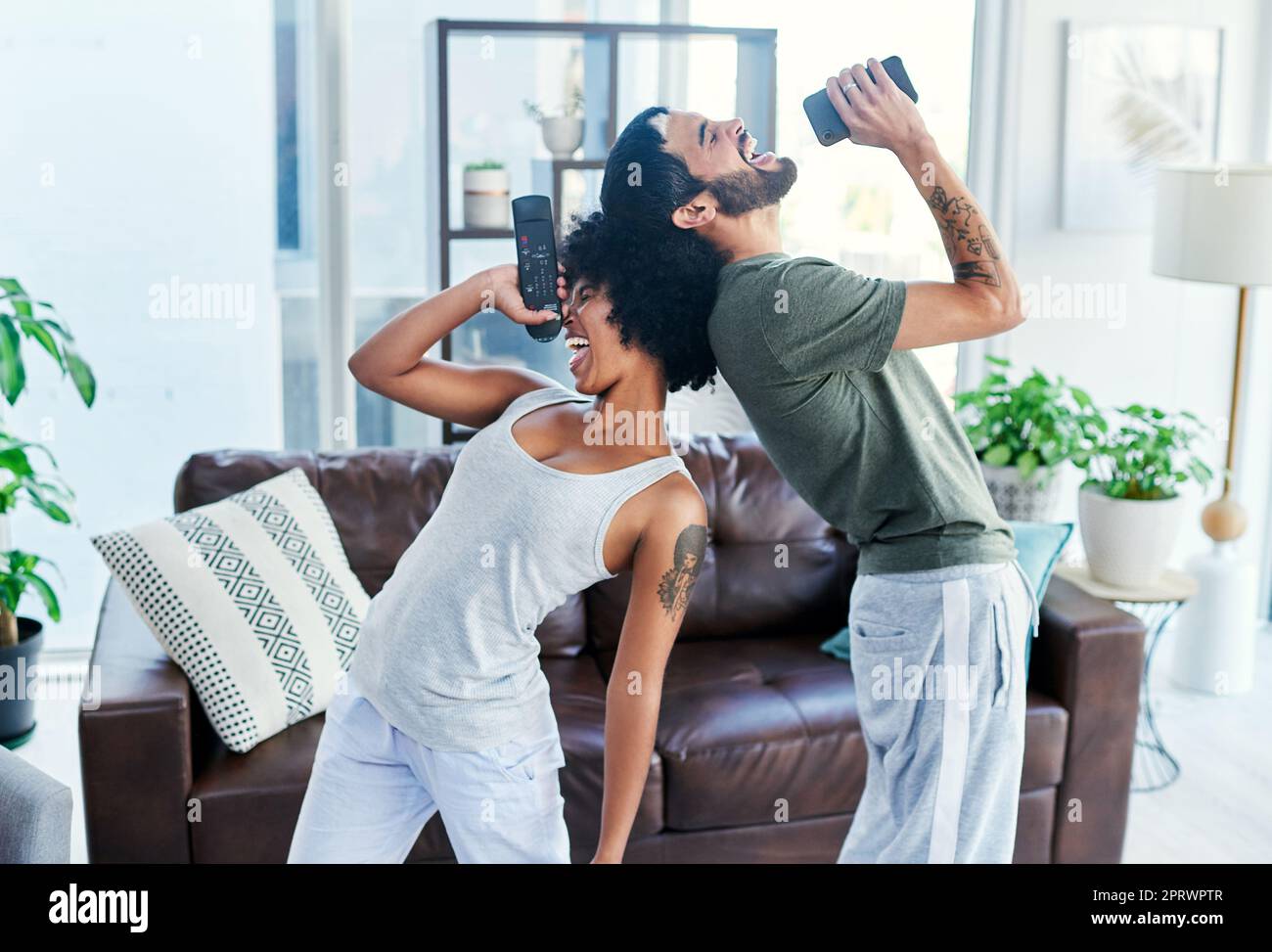 The perfect duet. a couple having a sing along at home. Stock Photo
