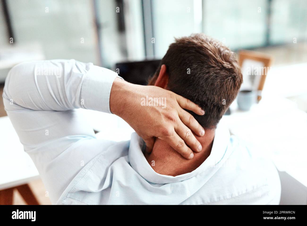 Working at a desk is a common cause of back and neck pain. Rearview